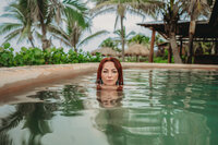 a woman dipping in a pool
