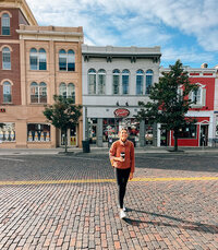 In Cincinnati, Ohio, a woman strolls along a brick road beside a building.