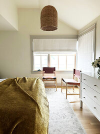 South Shore interior designer creates a minimal, comfortable bedroom in a new construction beach house with soft tones and airy coastal style.