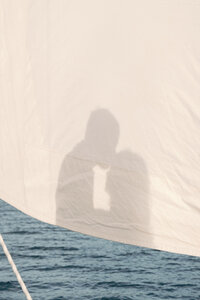 A shadow of a couple kissing on a sailboat on a lake in Middle Tennessee during their engagement photos. 