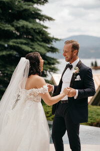 Bride and groom laughing and holding hands during a joyful first look, captured by a Washington wedding photographer.