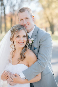 a bride and groom at Riverside park in the fall with a West Michigan wedding photographer
