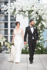 Bride and groom walking on a rooftop terrace