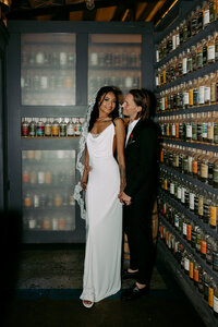 Bride and groom having couples portraits taken in front of a wine cellar