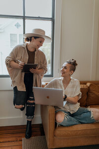 women looking at computer laughing