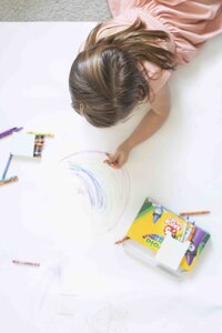 girl coloring with crayons