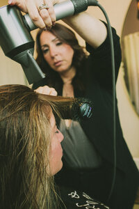 Amy Taylor, Owner and hairstylist at Art & Soul Hair Studio in New York blow drying hair