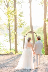 Alicia and Joey stand at the shore of the lake.