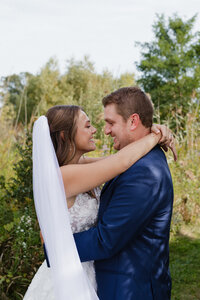 photo of bride and groom smiling at each other Wisconsin photographers wedding