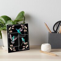 A mini art print display by Liz Lans Art featuring hummingbirds as sold on redbubble.