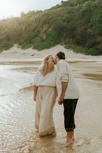A candid and romantic engagement photo on Hungry Head beach in Urunga