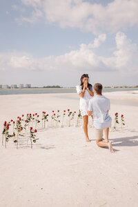 boyfriend proposing to his now fiance in Florida on the beach