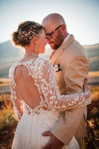 A happy couple embrace each other at sunset on their wedding day in Whitefish Montana.