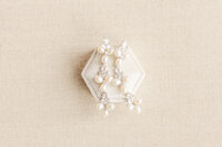 Details of pearl earrings on a ring box