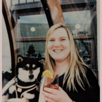 Crystal smiling next to her dog