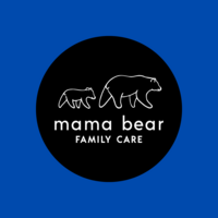 Woman smiling and holding a baby against her chest