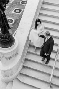 couple holding hands walking  jefferson memorial columns