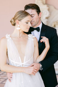 Elegant bride and groom embrace in a romantic editorial wedding portrait at The Ringling Museum in Sarasota. A luxury wedding photography moment with timeless elegance.