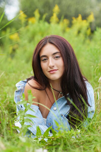 Senior girl laying in a field 