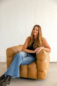 danielle muccillo of danielle muccillo photography posing for a branding session in a mesa az studio