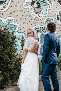 modern bride and groom in front of street art in melbourne