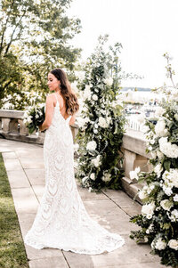 bride posing with flowers on wedding day in downtown cleveland