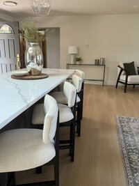 Contemporary living area with neutral palette and natural wood accents by KSC Interiors.