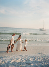 Portrait of a young family walking on the beach together