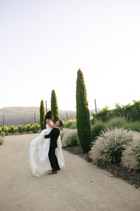 bride posing with her bridesmaids wearing champagne bridesmaids dresses