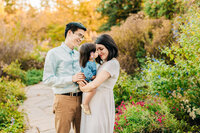 Couple plays with dog by lakeside in Springfield, VA