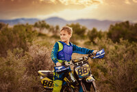 Little boy with dirtbike photoshoot in the mountains