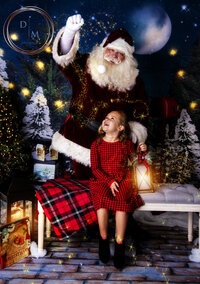 Little Girl staring in wonder at Santa and his magic 