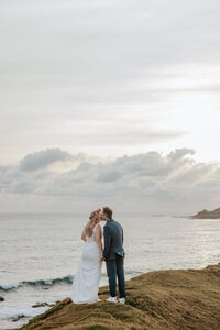 a husband and wife walking along the beach at white rock beach in Maui just after getting married in one of our all exclusive elopement packages