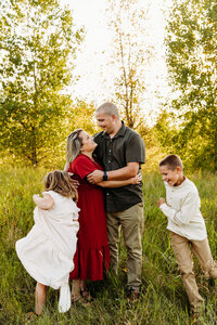 kids running around their mom and dad during their family session