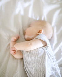 Newborn Baby snuggled in bed