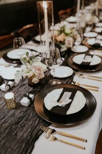 elegant black and white table setup at wedding reception