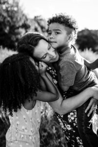 little girl grabs mothers face laughing during photoshoot