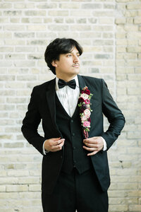A portrait of the groom during a luxury eclectic wedding at Prairie Springs Park in Milwaukee, Wisconsin. Photographed by Alexia Rodriquez, a destination wedding photographer known for timeless, editorial storytelling with personality and style.