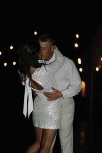 Bride and groom kissing at their Colorado wedding reception outside in the snow, on flash