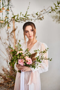 very-nice-young-woman-holding-big-beautiful-colorful-wildflowers-wedding-bouquet-delicate-wedding-bouquet-hands-bride-wearing-delicate-lingerie_125398-139