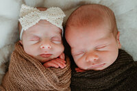 Parents lovingly admiring their newborn during a cozy in-home lifestyle photography session near Charlotte, NC.