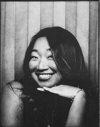 Smiling self-portrait of luxury destination wedding photographer, Lauren Ahn, cropped to a single frame from a vintage photobooth.