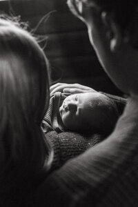 photo of a newborn holding dad's hand