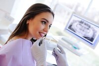 Young woman at dental office looking at options for a tooth restoration