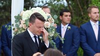 Groom wipes tears after seeing bride