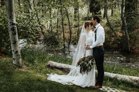 groom kissing bride on head