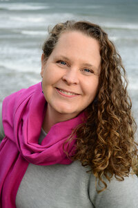 Woman smiling in a pink scarf