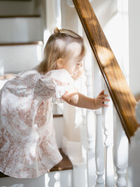 Pearland in home studio session with little girl on staircase- captured by AMP. 