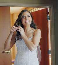 Snapshot from a Boston wedding film of the bride smiling warmly at the camera