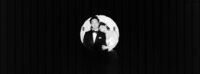 creative portrait of wedding couple in a circular spotlight at Audain Art Museum Whistler
